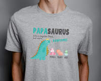 Load image into Gallery viewer, a man wearing a gray t - shirt with a dinosaur on it
